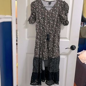 Black with small pink/orange flowers. 10/12